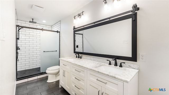 bathroom featuring walk in shower, vanity, and toilet