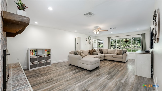 living room with hardwood / wood-style flooring and ceiling fan