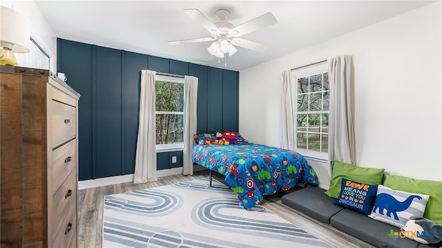 bedroom with ceiling fan and light hardwood / wood-style flooring