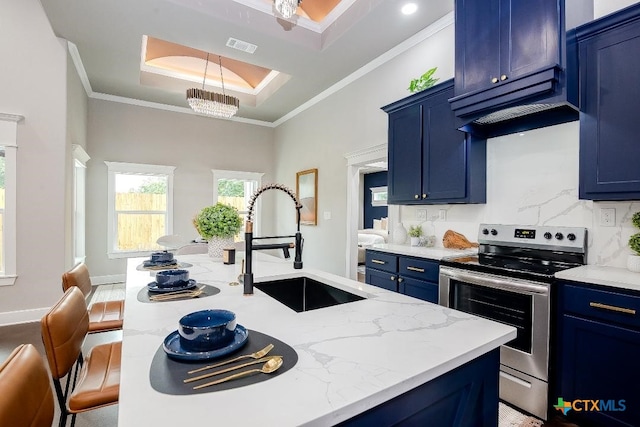 kitchen with stainless steel range with electric cooktop, blue cabinetry, a sink, ornamental molding, and light stone counters