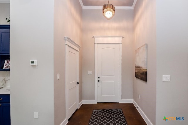 doorway featuring baseboards, crown molding, concrete floors, and a chandelier