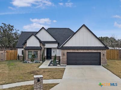 view of front of house with a garage and a front lawn