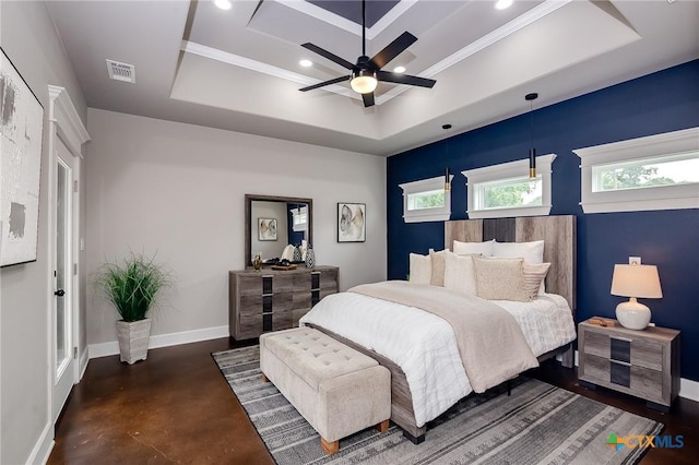 bedroom with ceiling fan and a tray ceiling