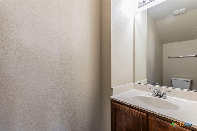 bathroom featuring vanity and toilet