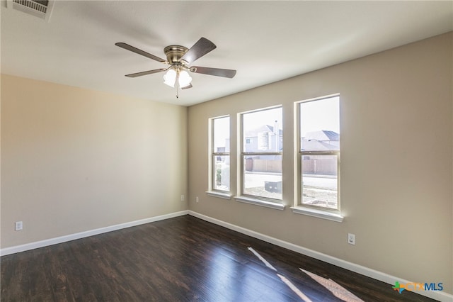 empty room featuring ceiling fan and dark hardwood / wood-style flooring