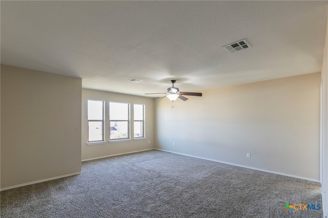 carpeted spare room featuring a textured ceiling and ceiling fan