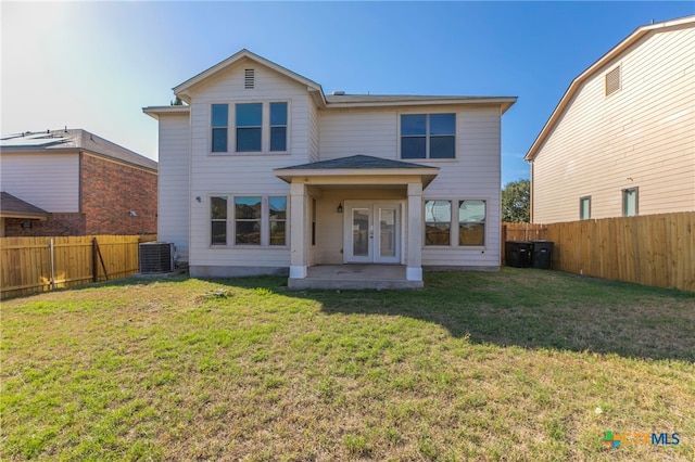 back of house featuring a patio, a lawn, french doors, and central air condition unit