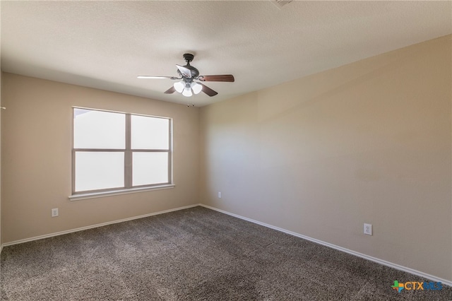 carpeted spare room with a textured ceiling and ceiling fan