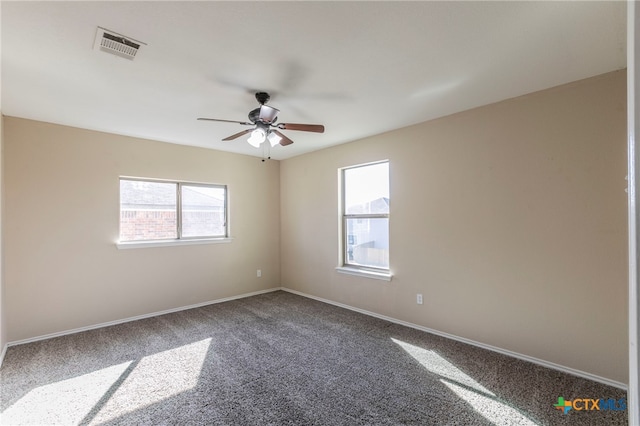 carpeted spare room with ceiling fan