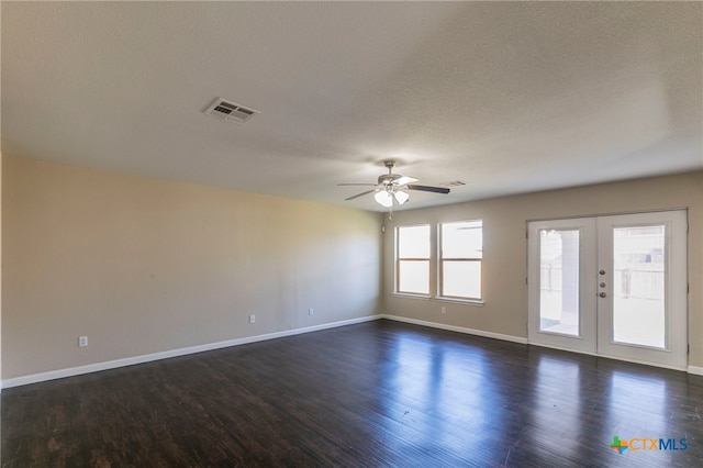 unfurnished room featuring french doors, dark hardwood / wood-style flooring, a textured ceiling, and ceiling fan