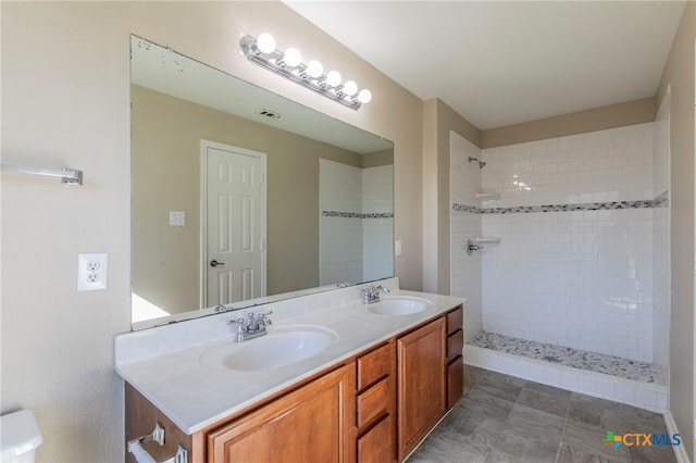 bathroom featuring vanity and a tile shower