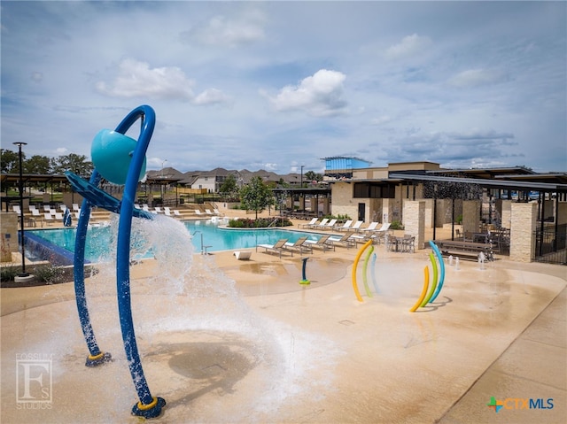 view of swimming pool with a patio area and a water slide