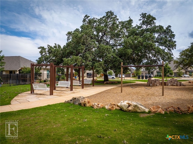 surrounding community featuring a playground and a lawn