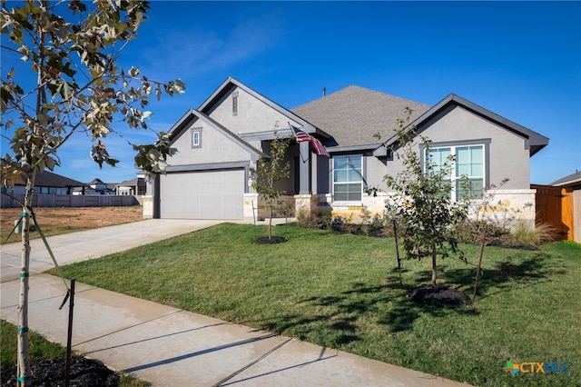 view of front of house with a front yard and a garage