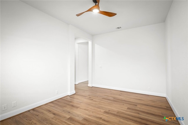 empty room featuring ceiling fan and light wood-type flooring