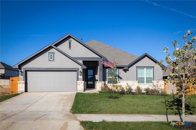 view of front of house featuring a front yard and a garage