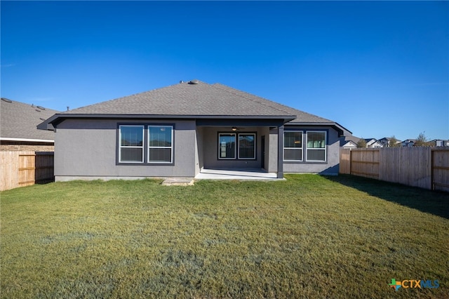 back of property featuring a patio area and a yard