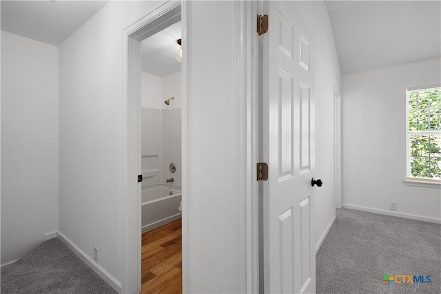 hallway with light colored carpet