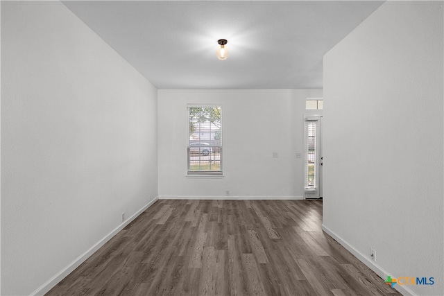 empty room with dark wood-type flooring