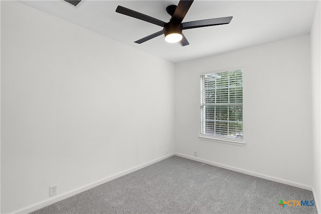 spare room featuring ceiling fan and carpet flooring