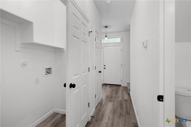 laundry area featuring hookup for a washing machine and light hardwood / wood-style flooring