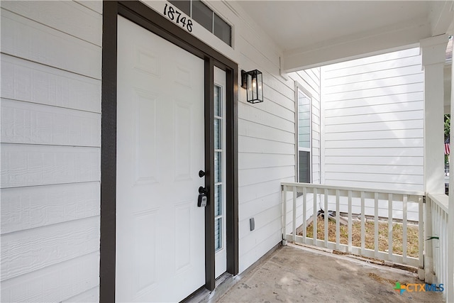 view of exterior entry with covered porch