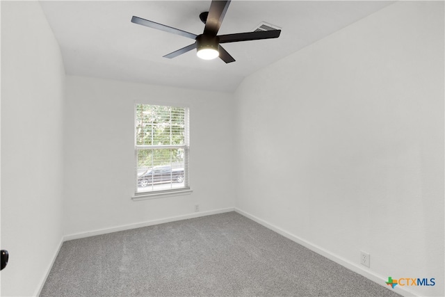 carpeted empty room featuring ceiling fan and lofted ceiling