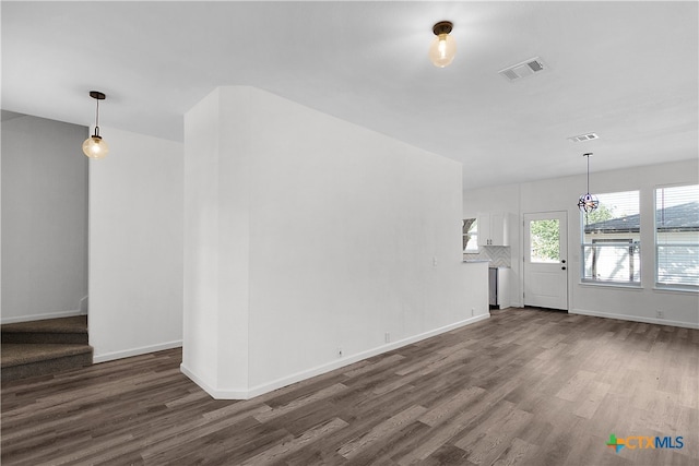 unfurnished living room featuring dark hardwood / wood-style flooring