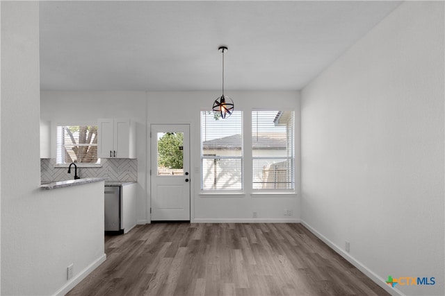 unfurnished dining area featuring hardwood / wood-style floors