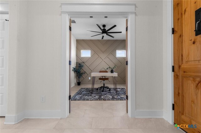 interior space with a textured ceiling, light carpet, and light brown cabinetry