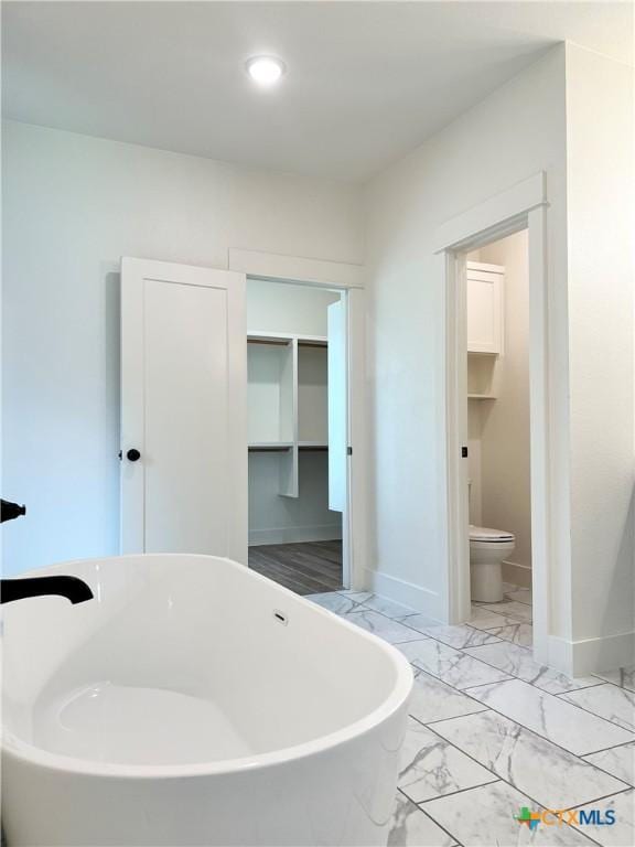 2819 Isaac Cir, Belton, TX 76513 - full bathroom with a soaking tub, marble finish flooring, baseboards, toilet, and recessed lighting