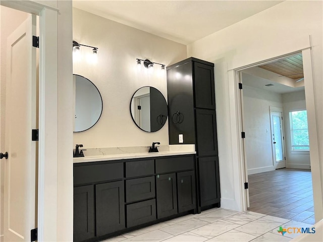 2819 Isaac Cir, Belton, TX 76513 - full bathroom featuring double vanity, marble look tile flooring, and baseboards