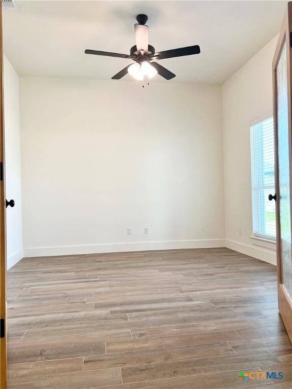2819 Isaac Cir, Belton, TX 76513 - spare room featuring wood finished floors, a ceiling fan, and baseboards