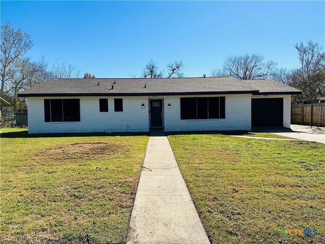 ranch-style home with a front lawn and a garage