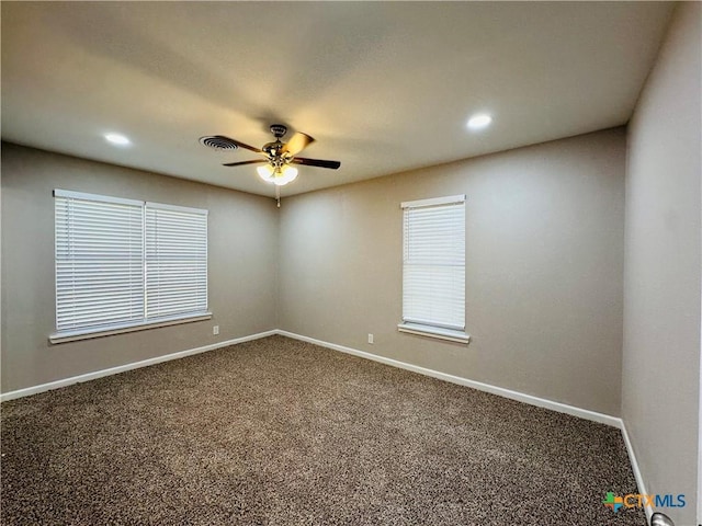 empty room with ceiling fan and carpet flooring