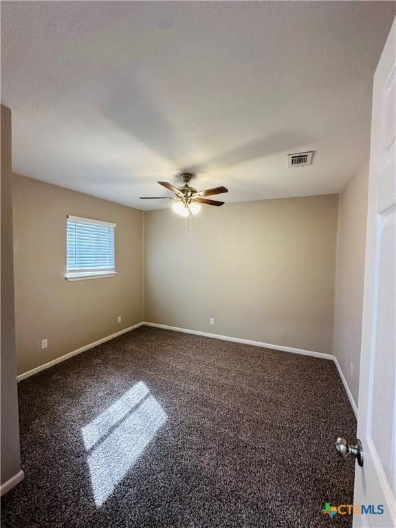 empty room with ceiling fan and carpet floors