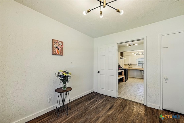 802 Cloud St, Killeen, TX 76541 - empty room with dark wood-type flooring and a chandelier