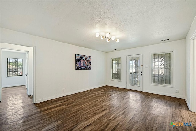 802 Cloud St, Killeen, TX 76541 - empty room with dark wood finished floors and a textured ceiling