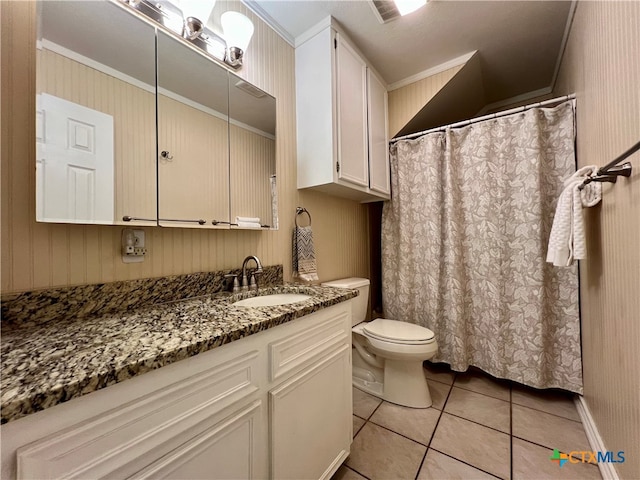 bathroom featuring toilet, vanity, crown molding, and tile patterned flooring