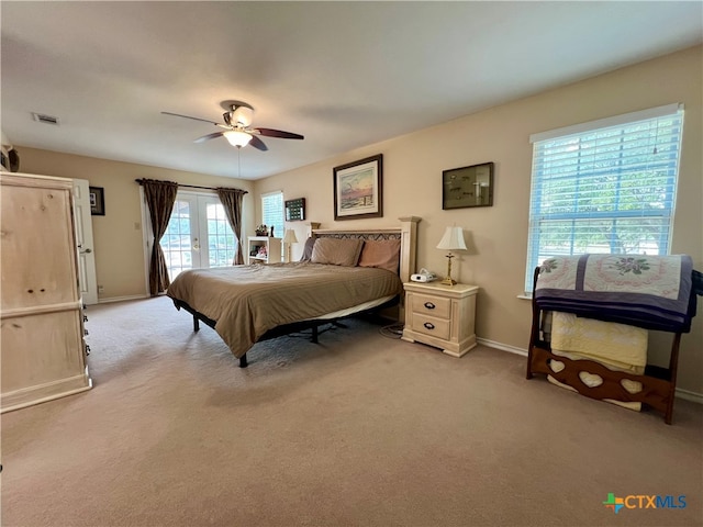 bedroom with ceiling fan, light colored carpet, and access to exterior