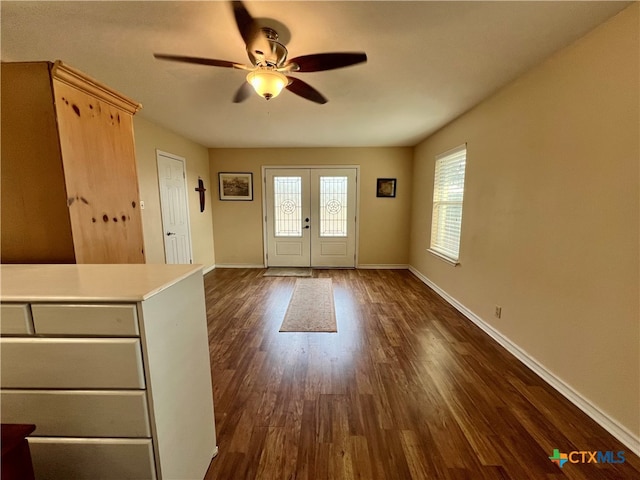 entryway with ceiling fan, french doors, and dark wood-type flooring