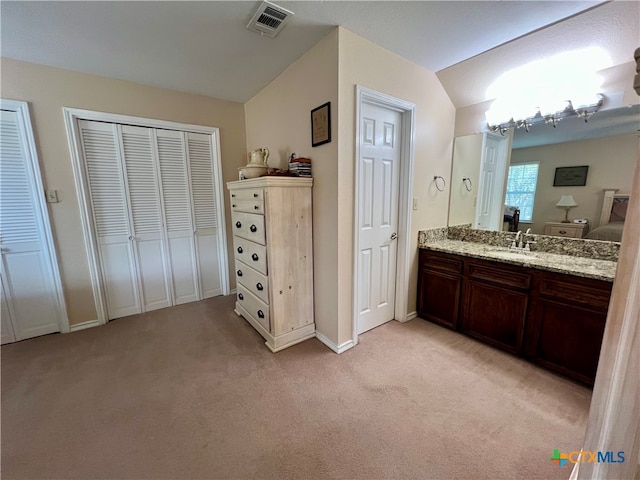 bathroom with vanity and vaulted ceiling