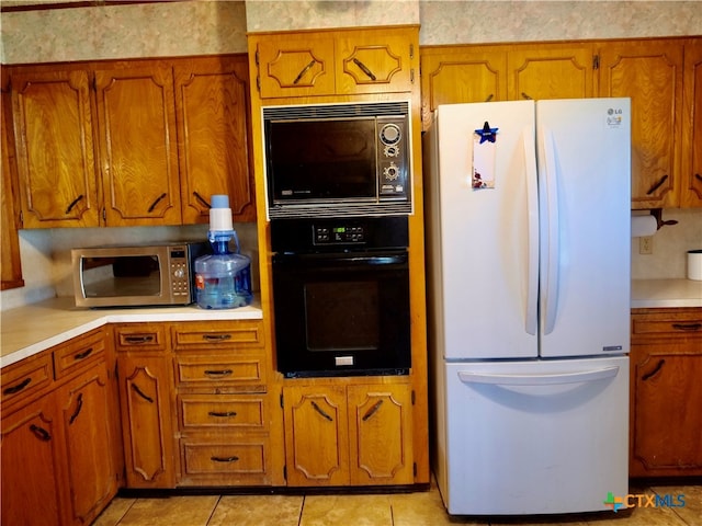 kitchen featuring black appliances and light tile patterned floors