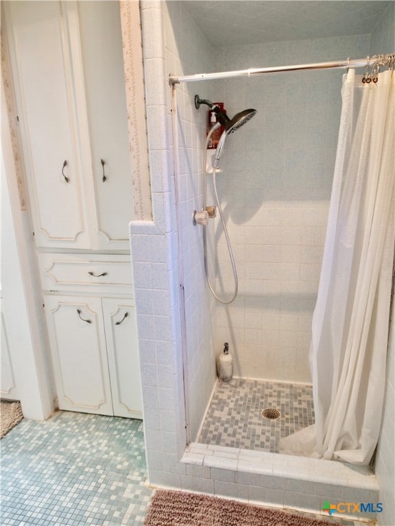 bathroom featuring tile patterned floors and curtained shower