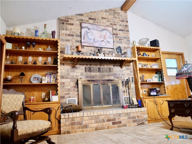 tiled living room featuring a textured ceiling, a fireplace, and vaulted ceiling with beams