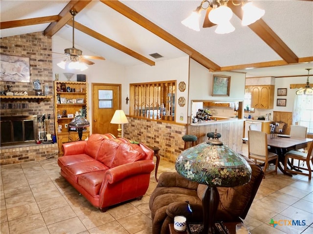 4410 Fm 1115, Flatonia, TX 78959 - living area featuring a ceiling fan, light tile patterned flooring, plenty of natural light, a brick fireplace, and a textured ceiling