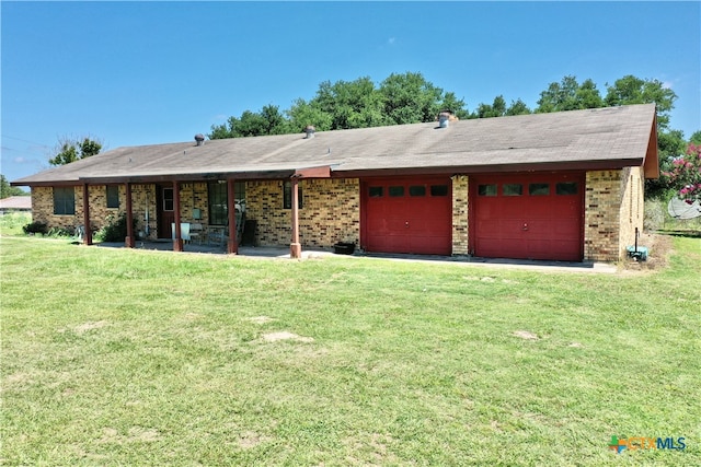 ranch-style home with a garage and a front lawn