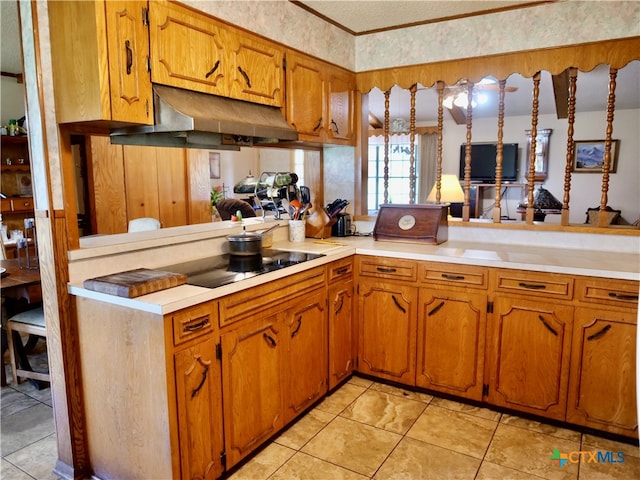 kitchen with black electric cooktop, light tile patterned floors, and kitchen peninsula