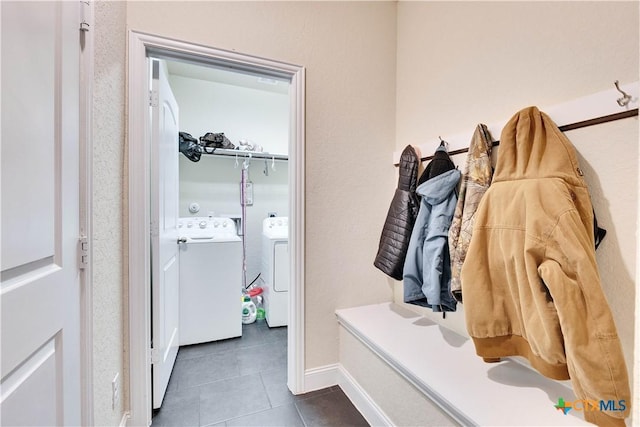 mudroom with washing machine and dryer, baseboards, and tile patterned flooring