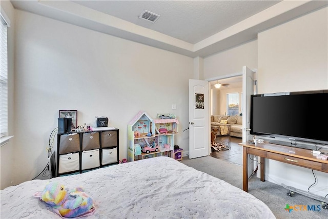 bedroom featuring carpet floors and visible vents